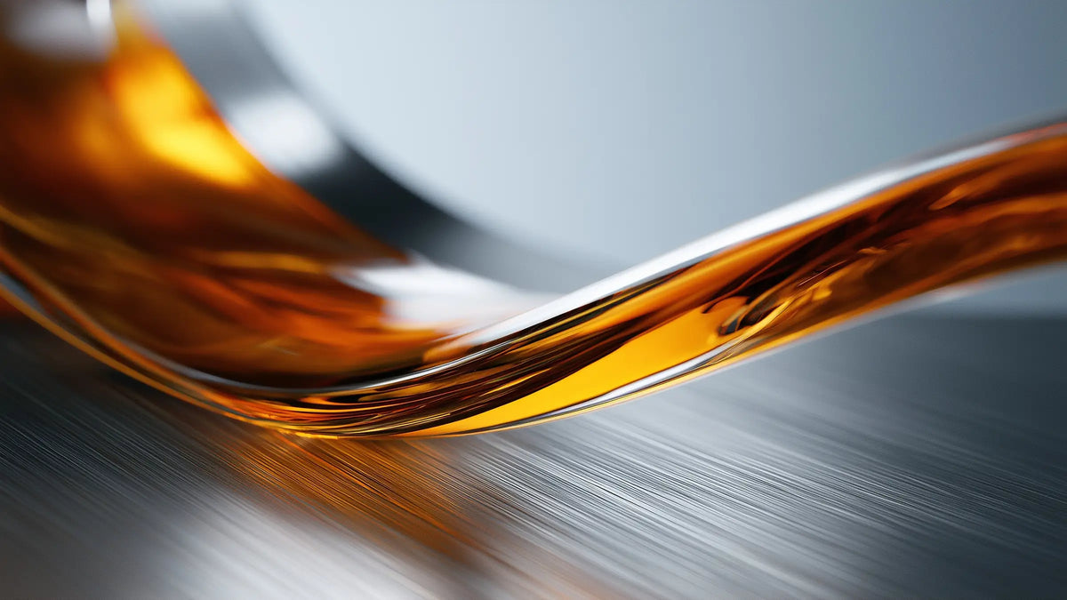 Amber oil flowing over steel for the Tech Tool Oemeta hydraulic oil guide