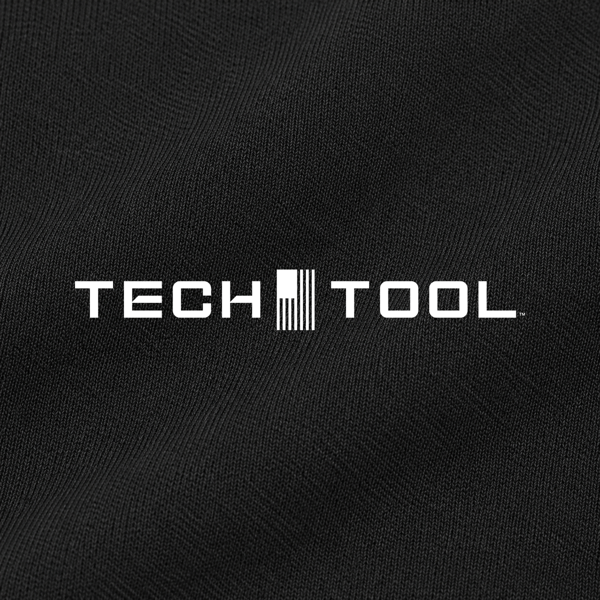 Tech Tool Unisex Core Quarter-Zip Pullover, macro detail render of the Tech Tool logo and smooth polyester interlock | Color: Black