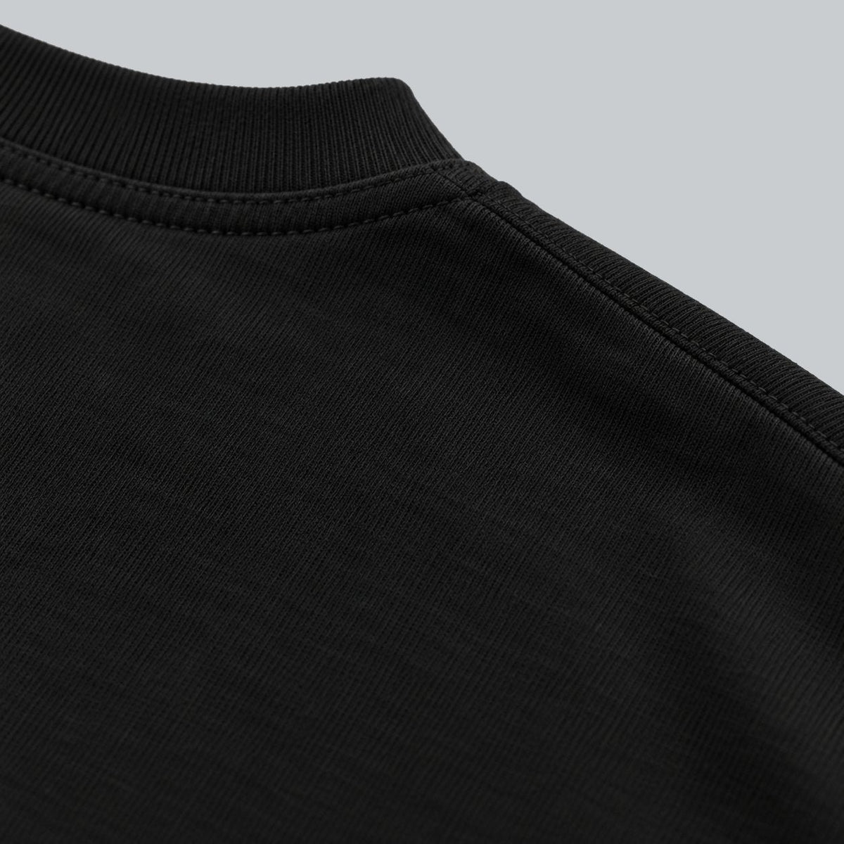 Premium Unisex Tech Tool Core T-Shirt, back construction macro showing crew neckline, shoulder stitching and cotton jersey | Color: Black