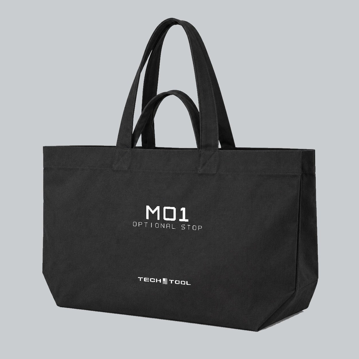 Optional Stop Tote, three-quarter view showing canvas body, gusset and M01 Optional Stop artwork