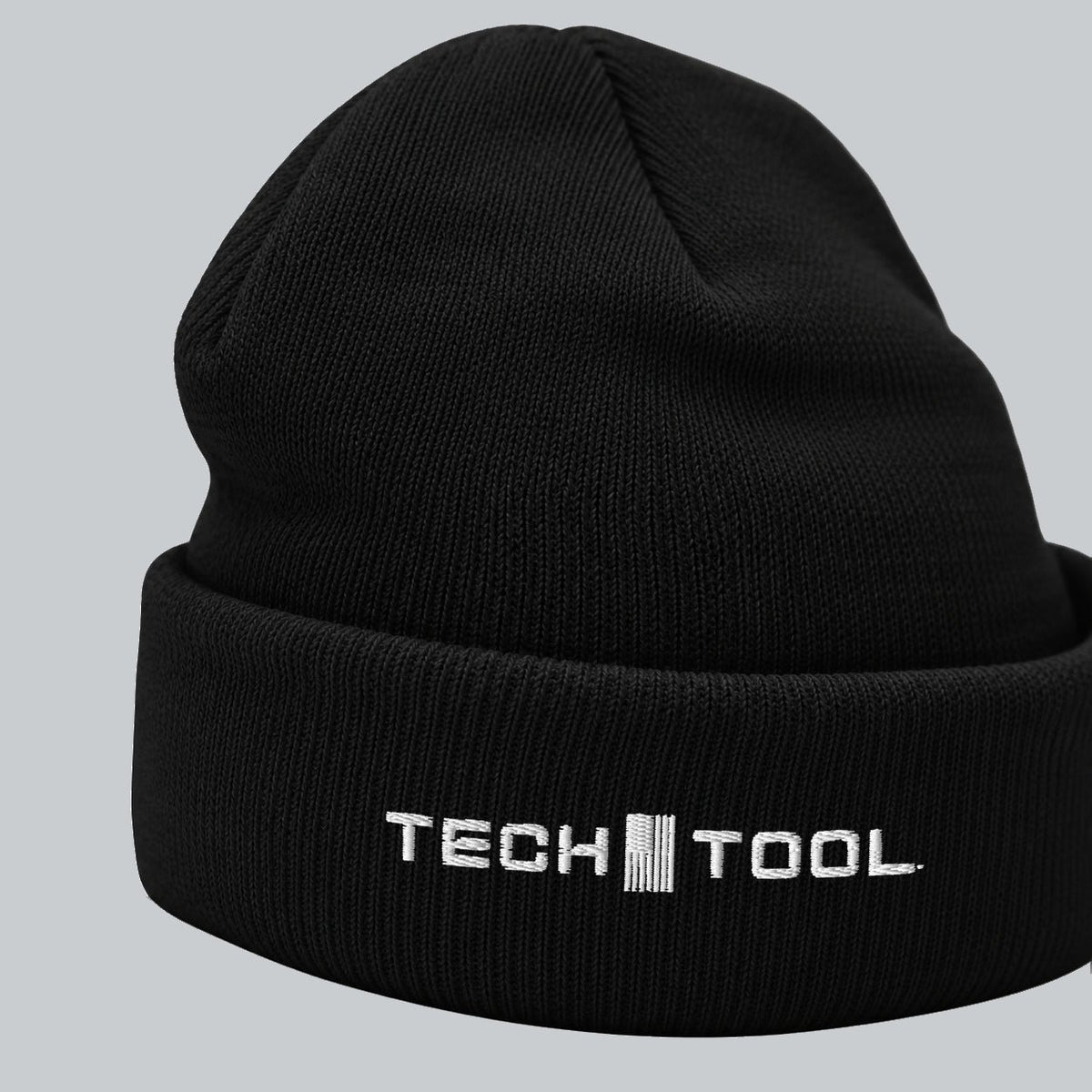 Tech Tool Core Cuffed Beanie, angled cuff view showing white Tech Tool embroidery and fine knit | Color: Black