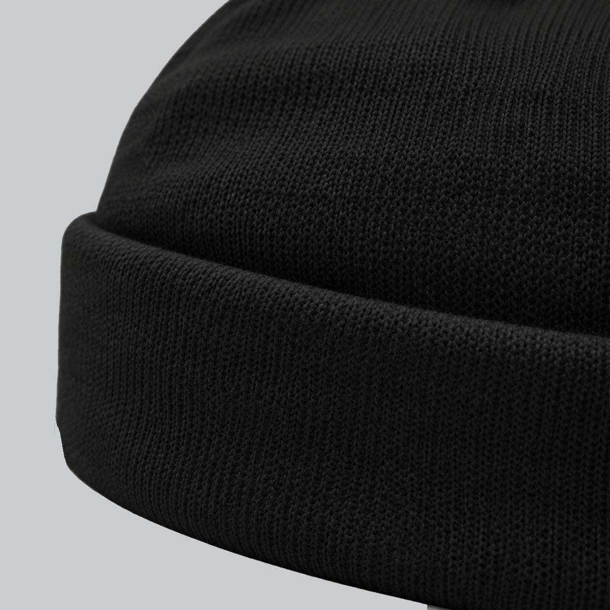 Tech Tool Core Cuffed Beanie, oblique macro of folded cuff thickness and fine acrylic knit | Color: Black
