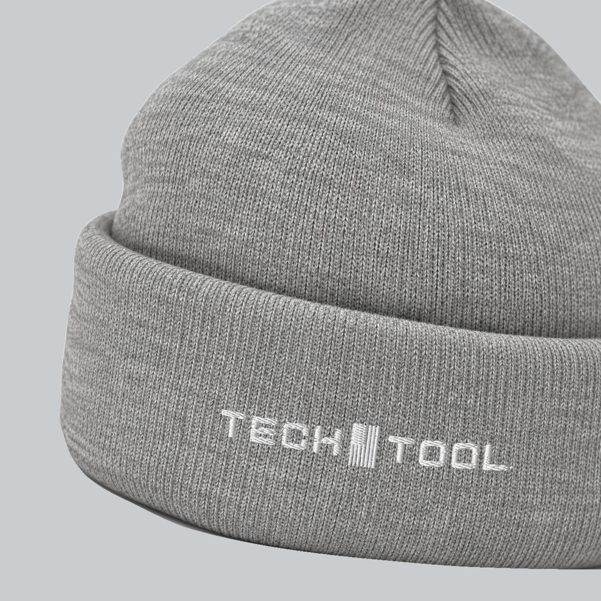 Tech Tool Core Cuffed Beanie, angled cuff view showing white Tech Tool embroidery and fine knit | Color: Heather Grey