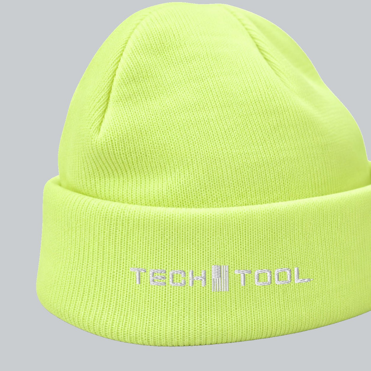 Neon Cuffed Beanie, angled cuff view showing white Tech Tool embroidery and fine knit | Color: Neon Yellow