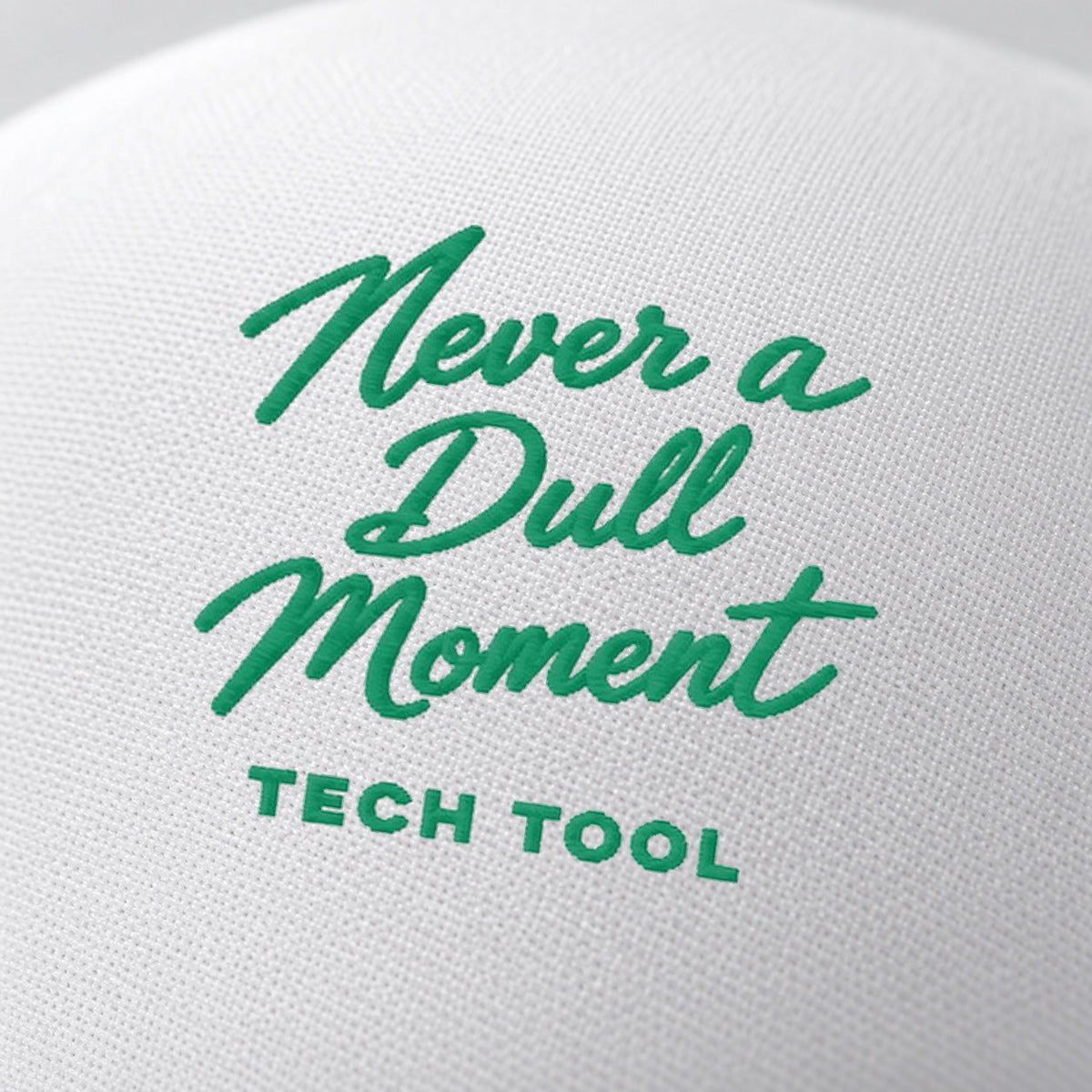 Never a Dull Moment Trucker Hat, oblique macro of Never a Dull Moment script embroidery and Tech Tool signature on white foam | Color: Fairway (Kelly Green / White)