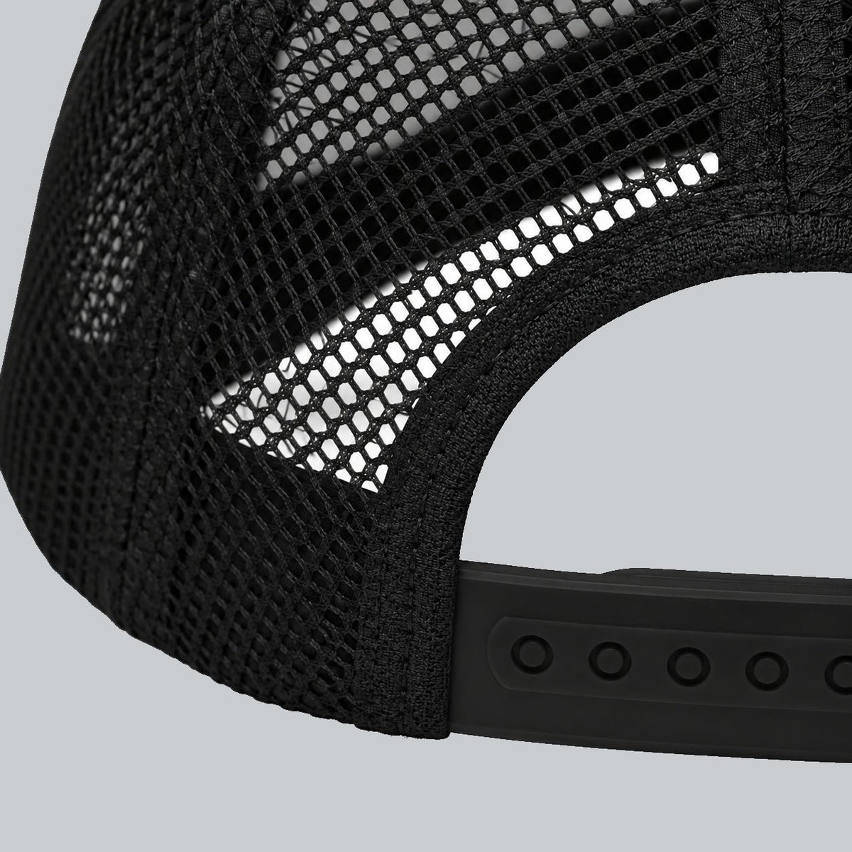 Never a Dull Moment Trucker Hat, oblique macro of mesh, bound back opening and adjustable snap attachment | Color: Obsidian (Black / White)