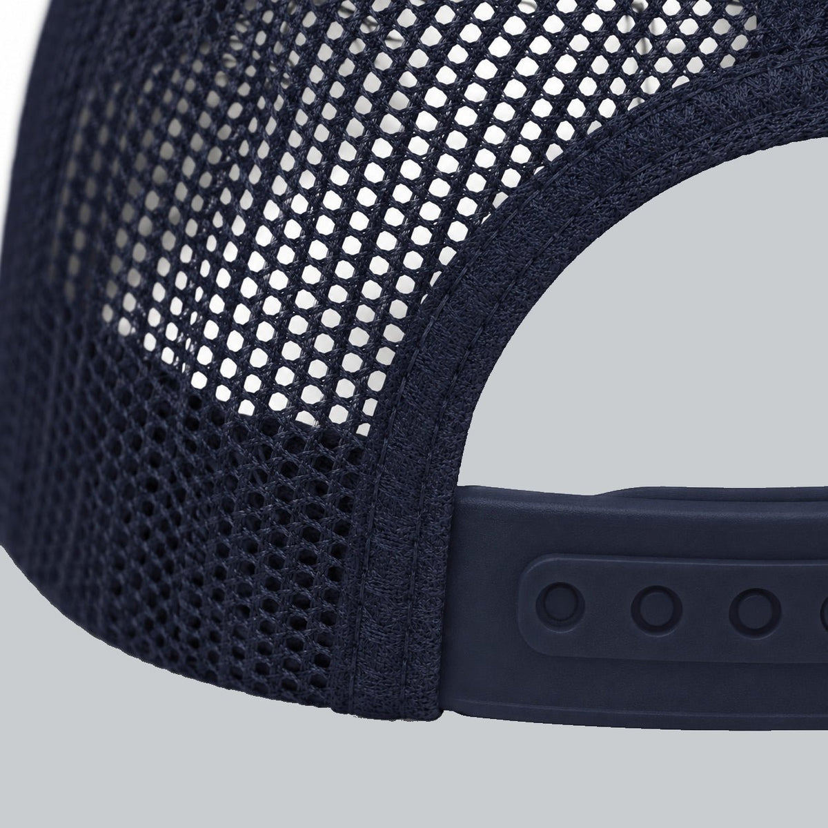 Never a Dull Moment Trucker Hat, oblique macro of mesh, bound back opening and adjustable snap attachment | Color: Midnight (Navy / White)