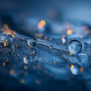 Close up of Oemeta ADDITIV HM additive on a blue coolant surface with detailed micro droplet clarity used by Tech Tool for the Hycut coolant system and carbide machining support