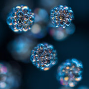 Oemeta HYCUT ET 46 EP power component oil shown as detailed micro droplet clusters on a blue coolant surface used by Tech Tool for Hycut coolant systems enhanced EP performance and all material safety