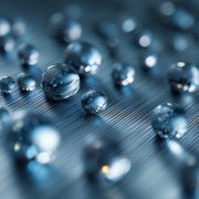 MQL droplets of Oemeta MICROTOL FA 20 gliding smoothly across brushed metal showing ultra clean minimal lubrication for machining