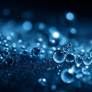 Oemeta UNIMET AS 260 semi synthetic coolant shown on a blue coolant surface with clear micro droplet detail used by Tech Tool for light to medium machining on steel stainless steel and cast iron