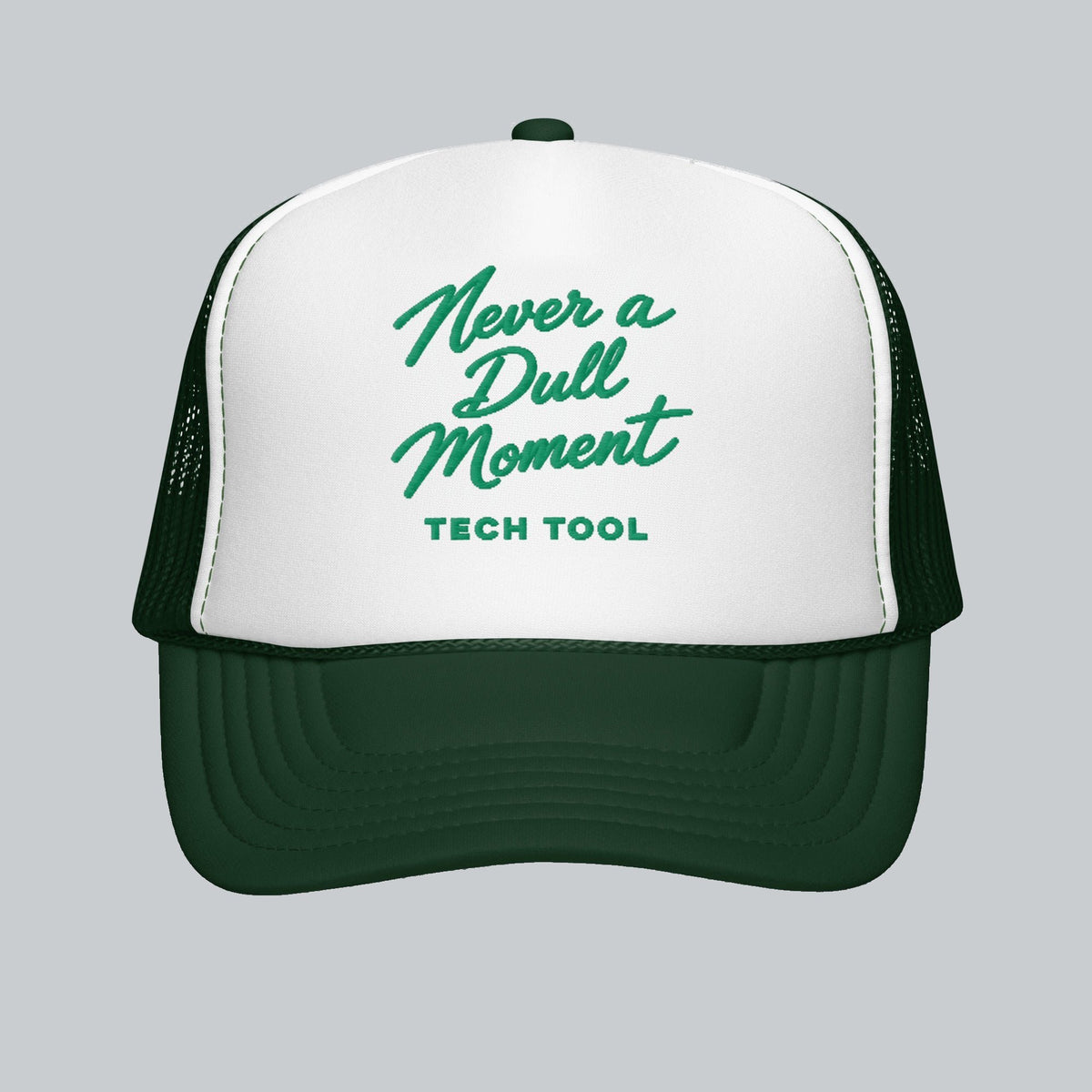 Never a Dull Moment Trucker Hat, front view showing Never a Dull Moment script embroidery and Tech Tool signature | Color: Evergreen (Dark Green / White)