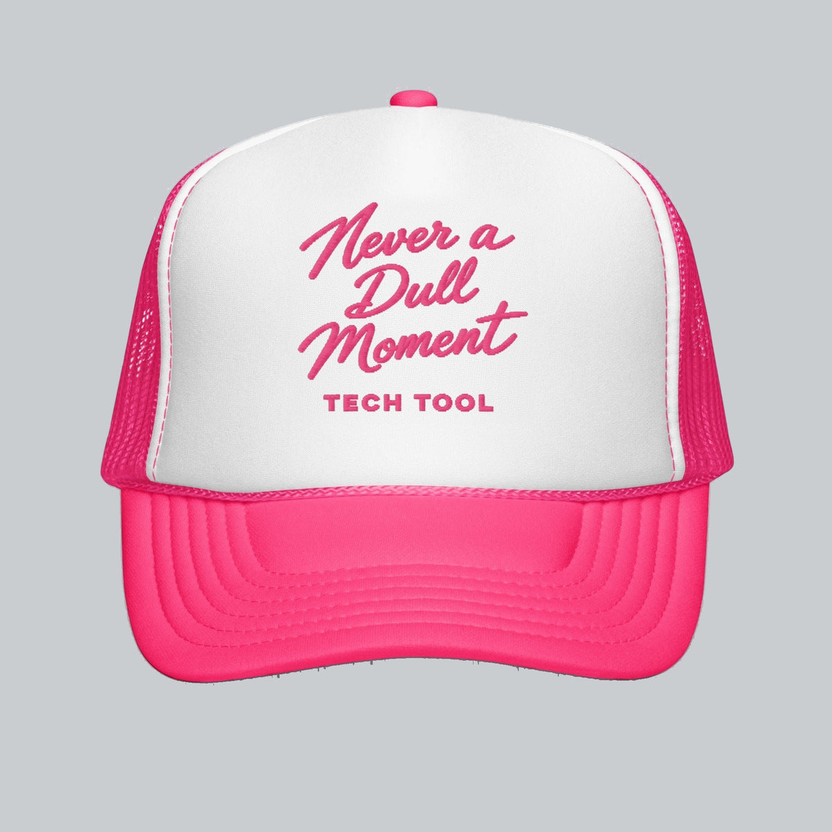Never a Dull Moment Trucker Hat, front view showing Never a Dull Moment script embroidery and Tech Tool signature | Color: Flamingo (Hot Pink / White)
