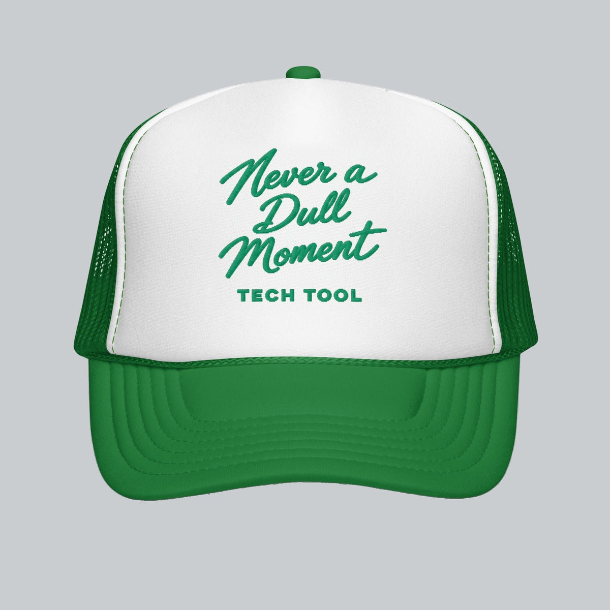 Never a Dull Moment Trucker Hat, front view showing Never a Dull Moment script embroidery and Tech Tool signature | Color: Fairway (Kelly Green / White)