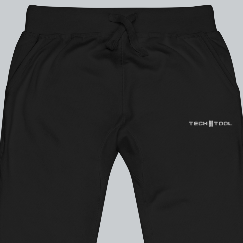 Tech Tool Unisex Core Fleece Joggers, waist and upper-thigh detail showing drawcord, pocket openings and full Tech Tool embroidery | Color: Black