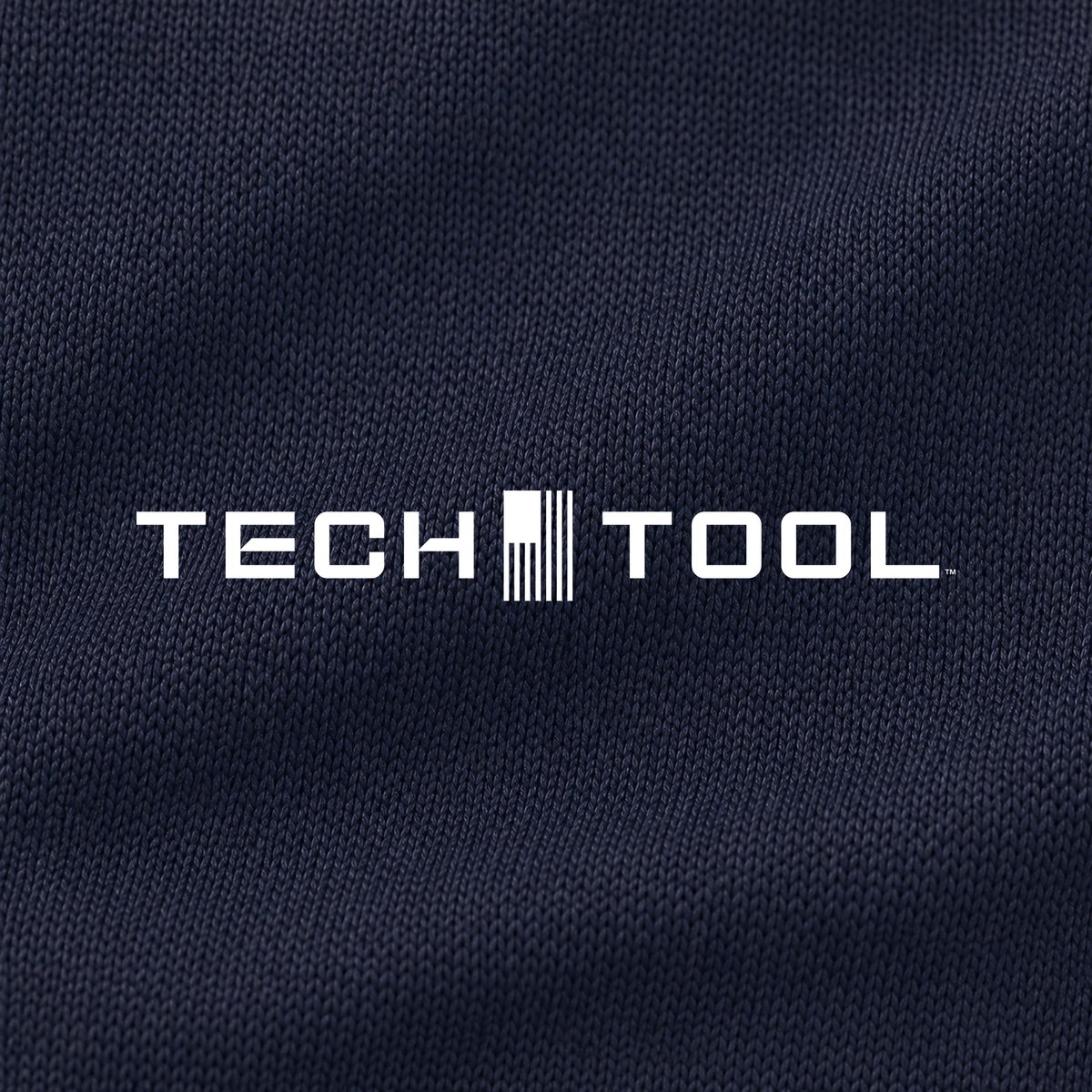 Tech Tool Unisex Core Quarter-Zip Pullover, macro detail render of the Tech Tool logo and smooth polyester interlock | Color: True Navy