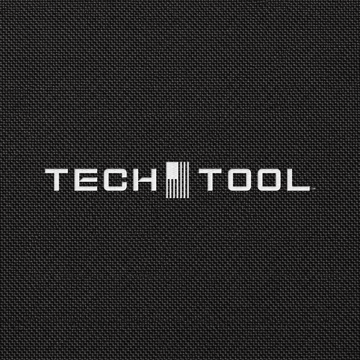 Tech Tool Unisex Core Windbreaker, detailed render of the full Tech Tool embroidery on matching polyamide shell fabric | Color: Black