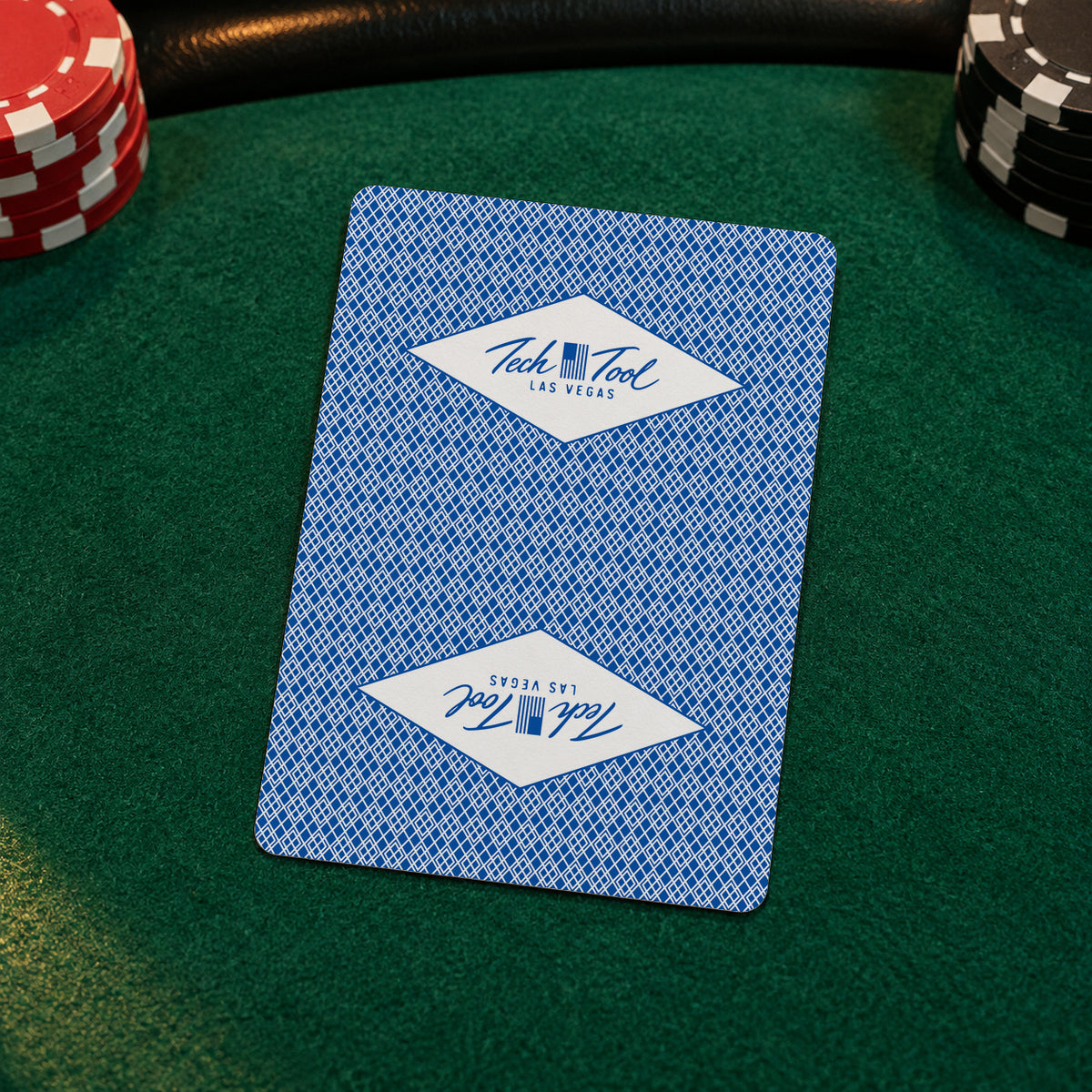 Tech Tool Las Vegas playing cards in blue, card-back close-up on green poker-table felt | Color: Vegas Blue