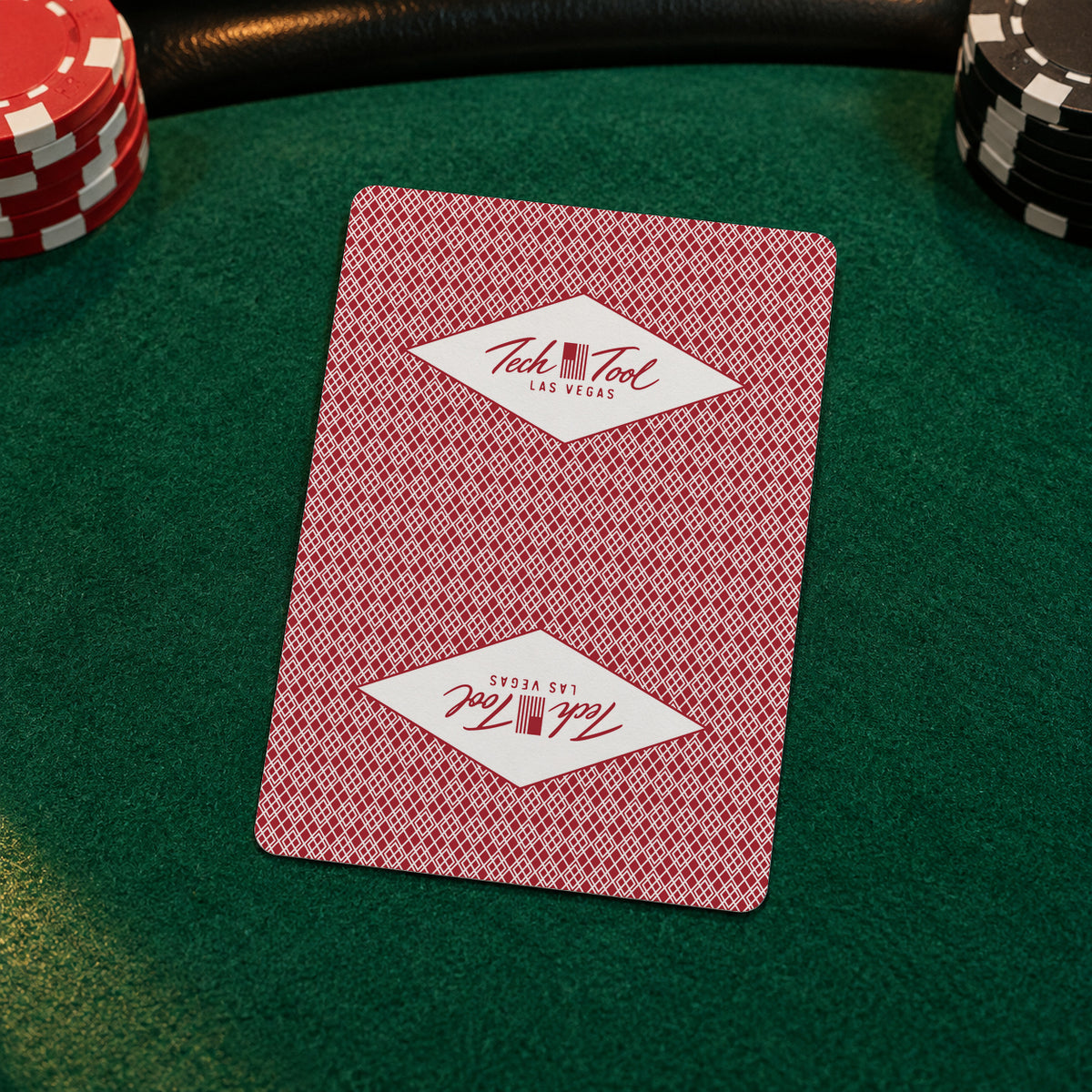 Tech Tool Las Vegas playing cards in red, card-back close-up on green poker-table felt | Color: Vegas Red