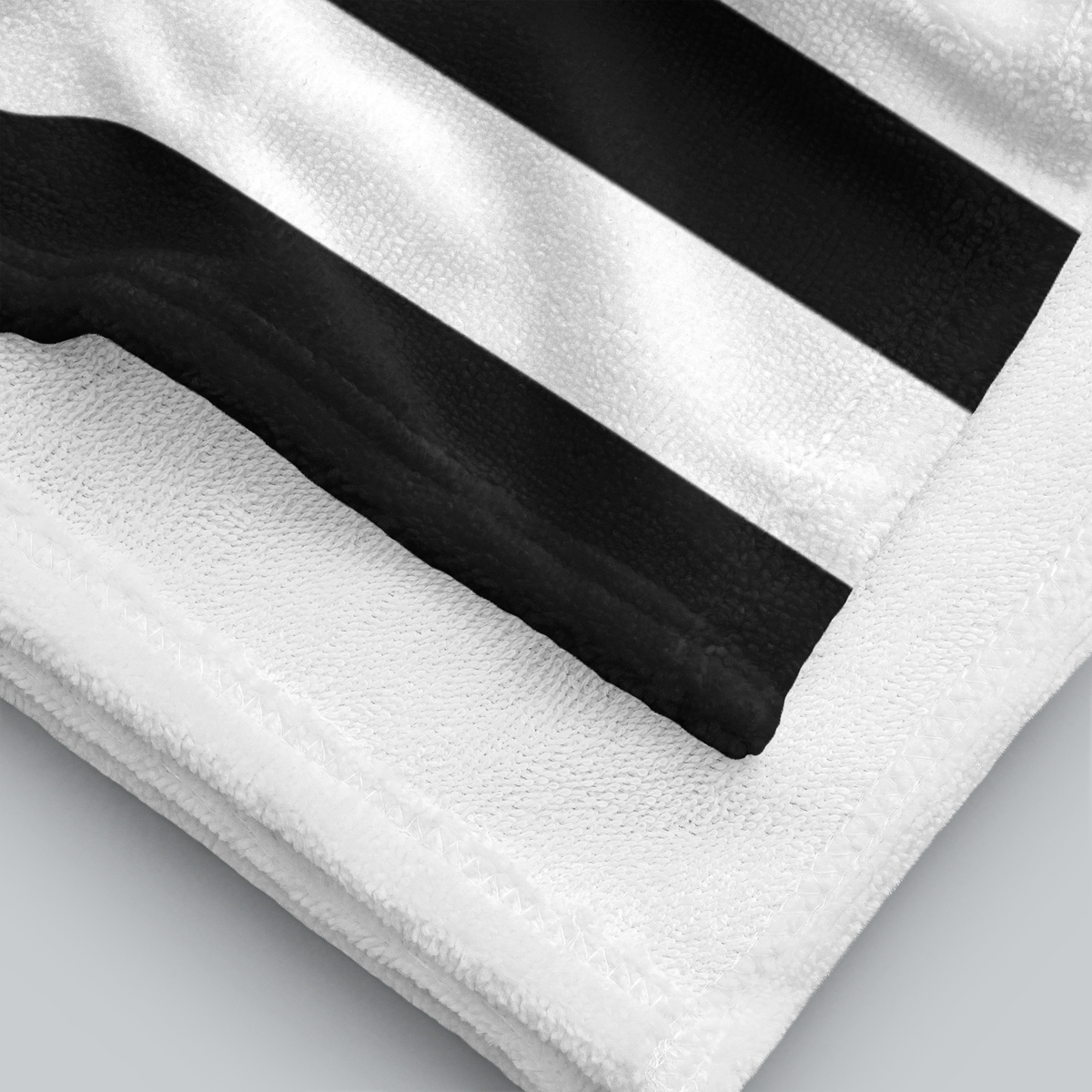 Tech Tool Signature Beach Towel in Black, folded printed face and white terry reverse | Color: Black