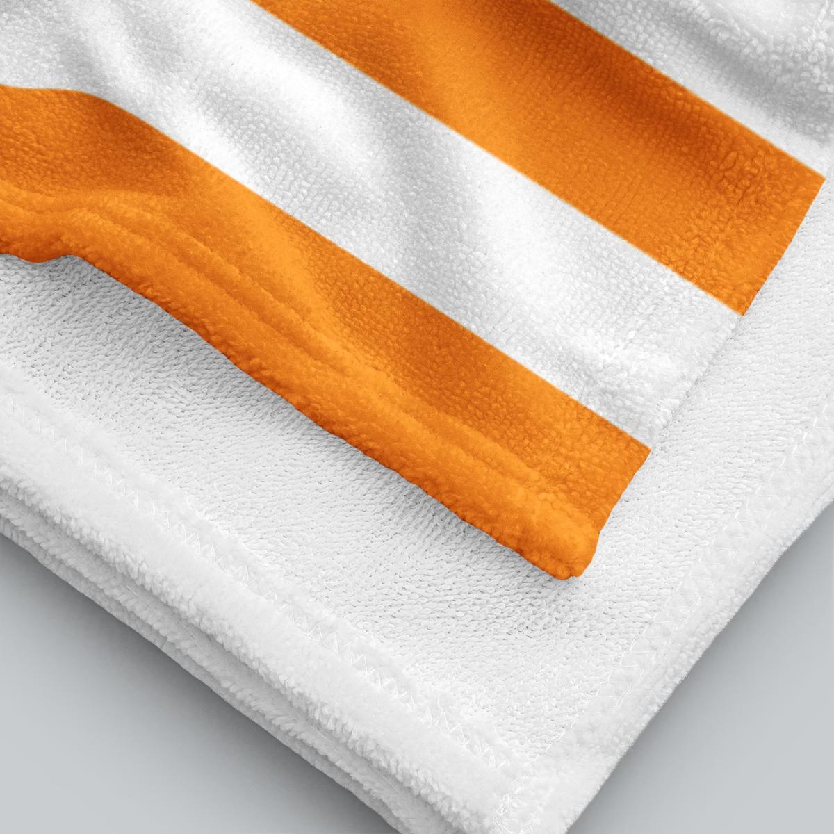 Tech Tool Signature Beach Towel in Mango Orange, folded printed face and white terry reverse | Color: Mango Orange