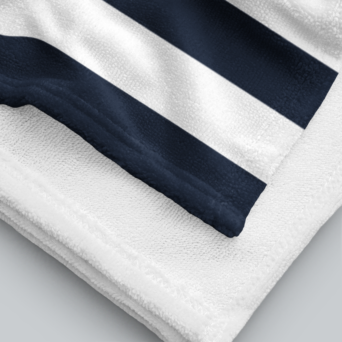 Tech Tool Signature Beach Towel in Navy, folded printed face and white terry reverse | Color: Navy