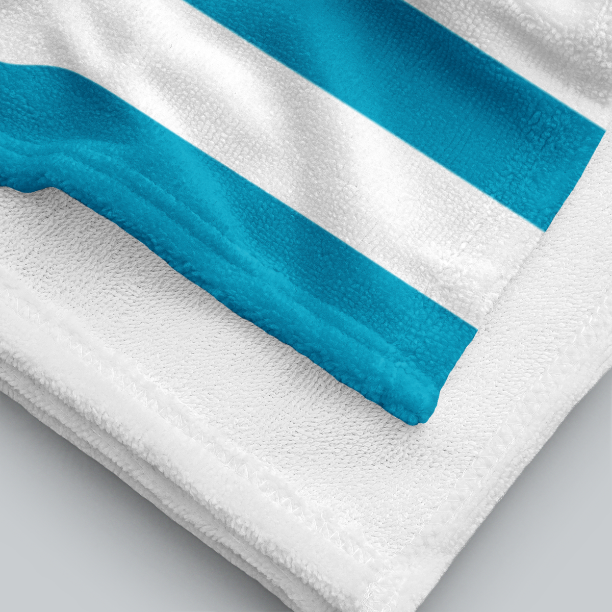 Tech Tool Signature Beach Towel in Tropical Blue, folded printed face and white terry reverse | Color: Tropical Blue