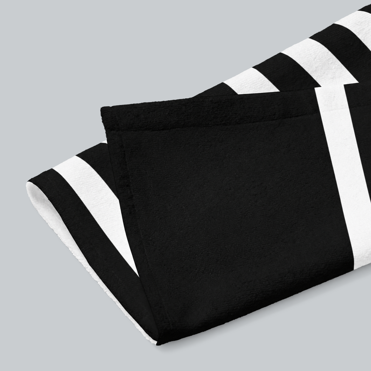 Tech Tool Signature Hand Towel in Black, folded print and hem detail with white reverse | Color: Black