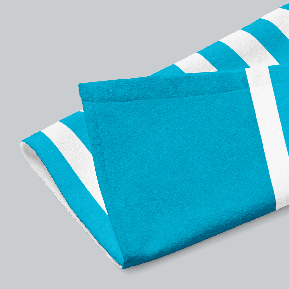 Tech Tool Signature Hand Towel in Tropical Blue, folded print and hem detail with white reverse | Color: Tropical Blue