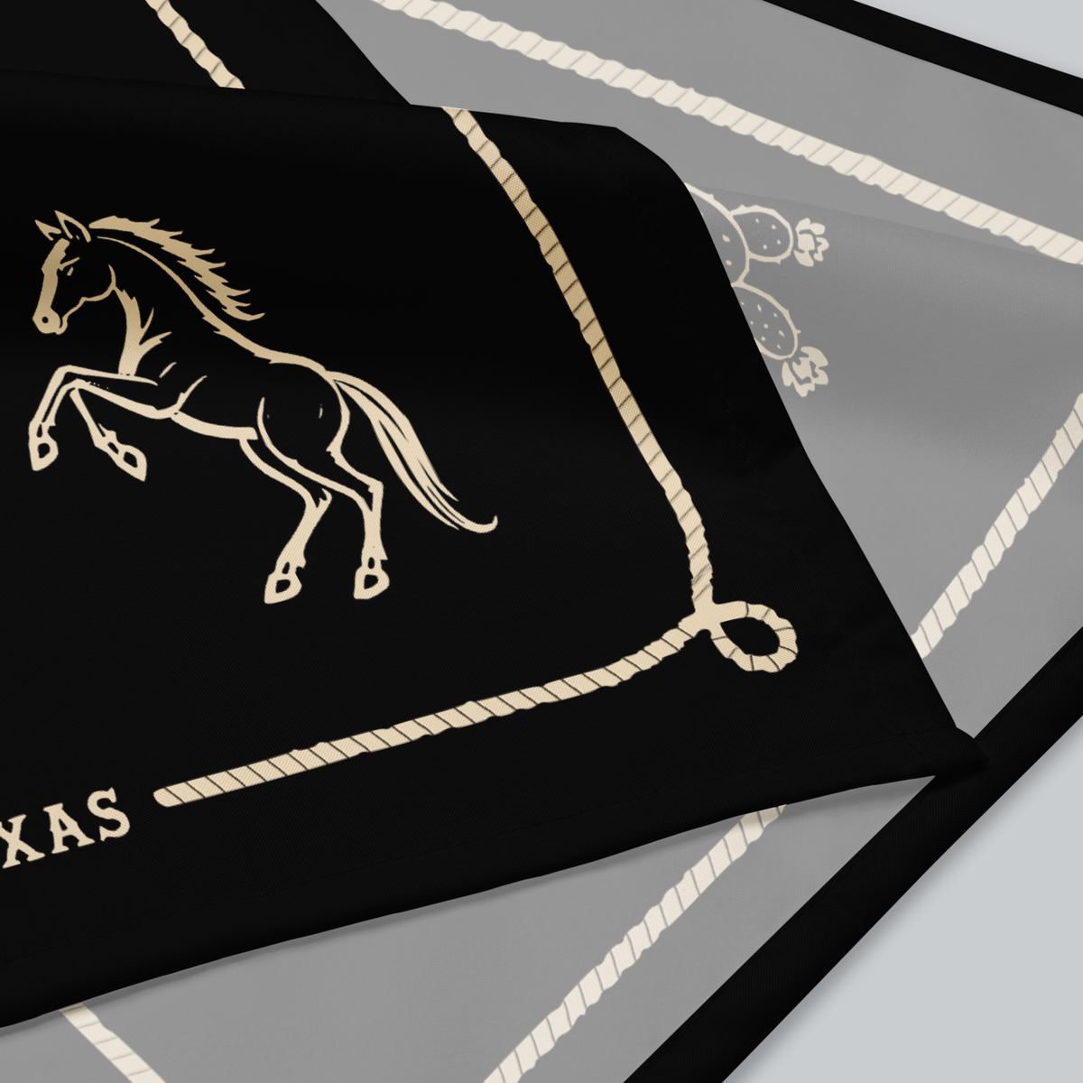 Tech Tool Texas Bandana, Keep Riding design, native folded fabric detail showing the horse illustration, printed rope border, and sewn edge | Design: Keep Riding