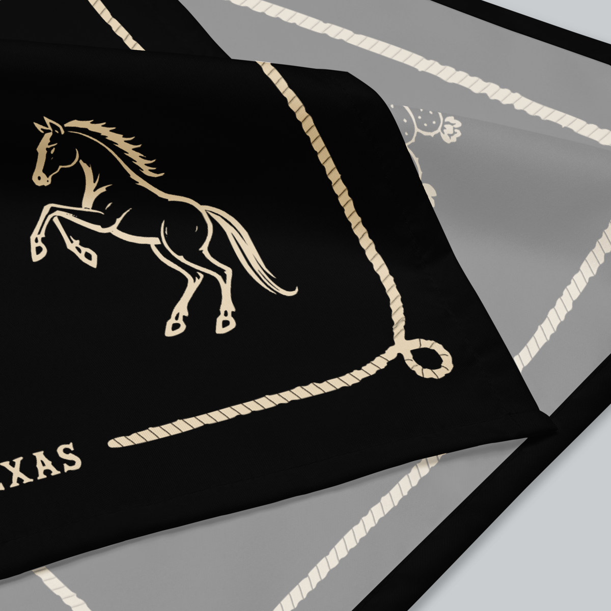Tech Tool Texas Bandana, Trail Pattern design, native folded fabric detail showing the horse illustration, printed rope border, and sewn edge | Design: Trail Pattern