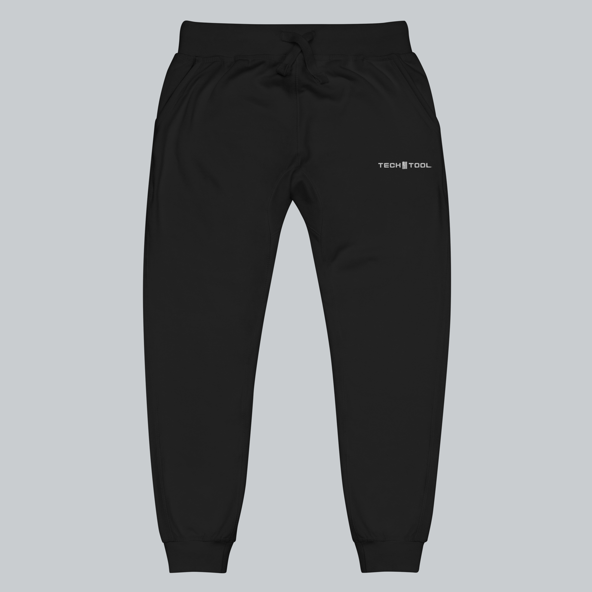 Tech Tool Unisex Core Fleece Joggers, front view showing upper-left-thigh Tech Tool embroidery, drawcord waist and cuffed legs | Color: Black