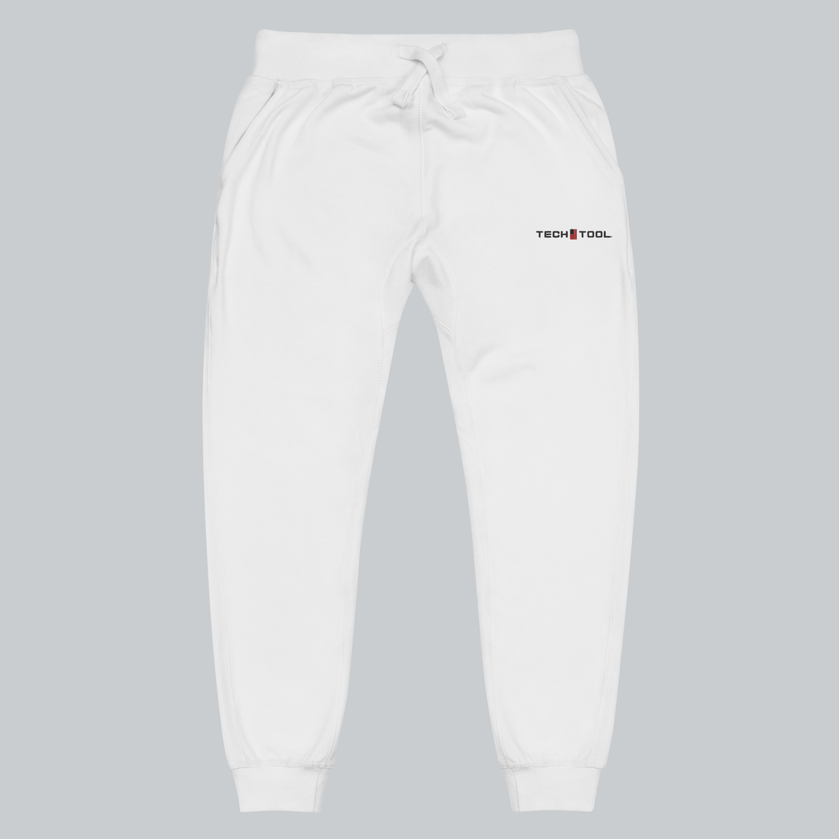 Tech Tool Unisex Core Fleece Joggers, front view showing upper-left-thigh Tech Tool embroidery, drawcord waist and cuffed legs | Color: White